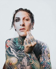 a man with tattoos on his body and hands