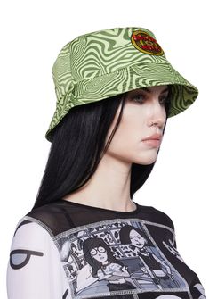 a woman with long black hair wearing a green hat