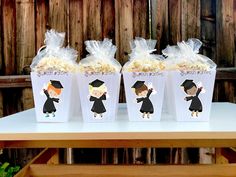 three bags of popcorn sitting on top of a table next to each other with cartoon characters