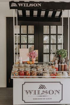 the wilson marquee stand is set up with jars and spices on it's sides