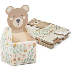 there is a box that has some paper in it and a bear on the inside