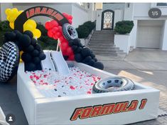 an inflatable race car with balloons and tires