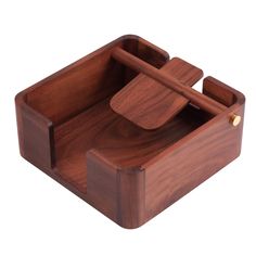 a wooden box with two compartments and a spoon in the middle, on a white background