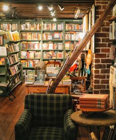 a room filled with lots of books and furniture in front of a book shelf full of books