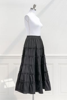 An elegant-yet-versatile skirt perfect for mixing-and-matching, the 100% cotton Antoinette skirt in black features tiers accented with ruffles, a comfortable elastic waistline, and flowy silhouette made for twirling! . Details: S: Waist 26"-32", Length 35" M: Waist 28"-34", Length 35.5" L: Waist 30"-36", Length 36" Elastic Waistline Material: 100% Cotton Unlined Care: Hand Wash Cold / Hang Dry Imported Ships in 1 to 2 Business Days Free US Shipping on Orders over $100