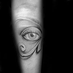 a woman's arm with an eye tattoo on it