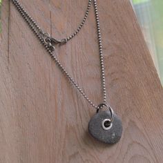 "Mens Riveted Beach Stone Necklace Silver Beach Stone Charm: This is a substantial pendant made from a natural black beach stone with a big 'ol sterling silver tube rivet and heavy silver ring. The stone has a nice soft feel and rugged texture. It hangs from a weighty sterling diamond-cut ball chain that is approximately 23.5 inches long and has a sturdy lobster-claw clasp. Pendant measures 1 1/4 inch high including ring by about 1\" wide. I had this in mind for a man, but a woman can pull this Black Natural Stones Jewelry For Beach, Silver Diamond Jewelry, Mens Necklace Pendant, Mens Silver Jewelry, Silver Diamond Necklace, Viking Necklace, Rock Jewelry, Long Silver Necklace, Rock Decor