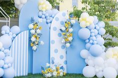 an outdoor area with balloons and flowers on it