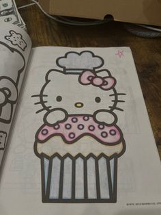 an open book with a hello kitty image on it