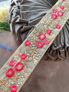 a close up of a ribbon with flowers on it