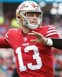 a close up of a football player throwing a ball