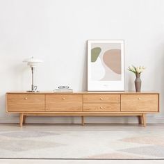 a living room scene with focus on the sideboard and vases sitting on top