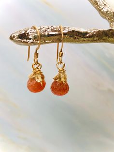 "Dainty sparkling sunstone brios (approx 12mm x 8mm) are raindrop cut and faceted with outstanding color and sparkle. Paired with Citrine rounds. This pair measures 1 1/8\" inches long including the ear wires. They are wrapped in 14k gold fill and hang from gold fill ear wires. The coordinating hair pin (pictured in last photo) is available in our store here: https://www.etsy.com/shop/BlueHeronJewelry?ref=seller-platform-mcnav&section_id=28051102 Blue Heron Jewelry and Hair Accessories have