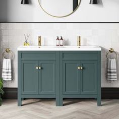 a bathroom vanity with two sinks and mirrors