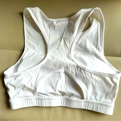 Never Worn, Like New Size Medium Cup Pads Included White Stretch Sports Bra With Built-in Padding, White Stretch Tops With Built-in Padding, White Seamless Training Tops, White Seamless Tops For Training, White Activewear With Built-in Bra For Sports, White Sleeveless Sports Bra For Light Sports, White Fitted Activewear With Medium Bust Support, White Sports Bra For Light Activities, White Fitted Sports Bra For Light Sports