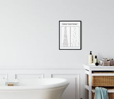 a white bath tub sitting next to a wall with a drawing on it's side