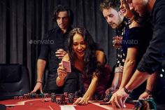 a group of people playing cards at a casino table