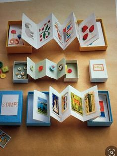 an open book sitting on top of a wooden table next to other books and magnets