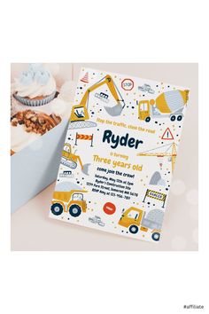 a baby's first birthday card with construction vehicles on it and cupcakes in the background