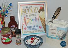 an ice cream sundae is sitting on a counter next to a sign and some other items