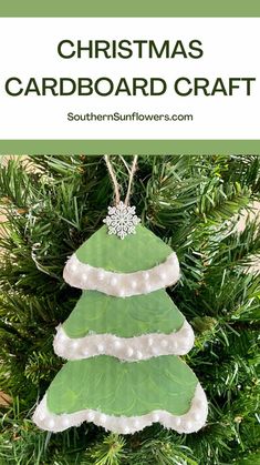 a green christmas tree ornament hanging from a pine tree with text overlay that reads, christmas card board craft