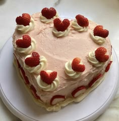 a heart shaped cake with strawberries on top