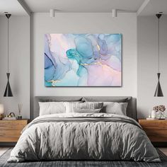 a large painting on the wall above a bed in a room with grey walls and furniture