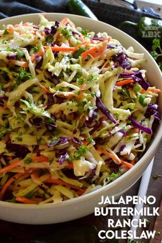 a white bowl filled with coleslaw and carrots on top of a table