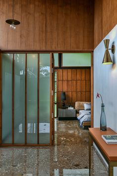 the interior of a house with wood paneling and glass doors