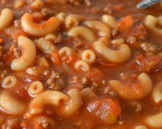 a bowl filled with pasta and meat soup