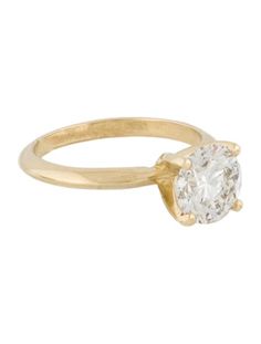 a yellow gold ring with a single diamond