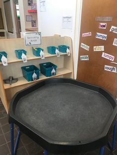 a black tray sitting on top of a table in front of a book shelf filled with books