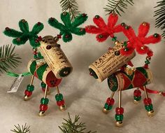 two wine cork reindeer ornaments with red and green decorations