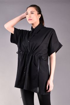 "Linen Shirts, Linen Blouse, Loose Linen Shirt, Linen Clothes. Linen blouse is the perfect choice for the summer as it keeps you cool even though it is black. This oversized shirt is loose fit but can be tightened at the waist thus the body will look more feminine and the waist area will be emphasized. The model features trendy kimono sleeves and a wide collar. It looks very stylish matched with black legging for all black look but added a colour popping handbag or shoes. ^ Sizes: The item can b Chic Short Sleeve Cotton Tunic, Oversized Cotton Blouse With Batwing Sleeves, Oversized Cotton Batwing Sleeve Blouse, Chic Cotton Tunic With Short Sleeves, Casual Tunic Shirt For Daywear, Cotton Tunic Tops For Work, Oversized Collared Top For Daywear, Oversized Short Sleeve Cotton Blouse, Oversized Cotton Short Sleeve Blouse