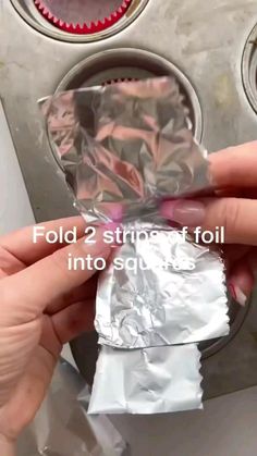 someone is holding some foil in front of a stove top burner with the words fold 2 strips at foll into each