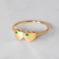 Our double heart ring isinspired by children's signet rings of the 70's and 80's. Set here with two emeralds. Band width 1.2mm Weight 1.7g (approximately) Pictured with a high shine finish. For a matte finish please leave a note at checkout. Double Heart Ring, Silver Heart Ring, J Us, Signet Rings, Black Ink Tattoos, Double Heart, Instagram Icons, Signet Ring, Promise Ring