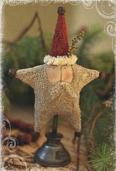 an old fashioned christmas decoration with a star on it's head and a bell in the foreground