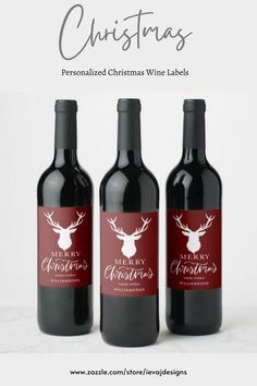 three bottles of wine with the words merry christmas written in white on top and bottom