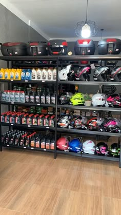 a motorcycle shop filled with lots of different types of helmets