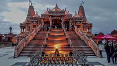 an ornate building with many steps leading up to it and people standing around in the background