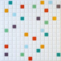 a white tile wall with multi colored squares on it's sides and one square in the middle