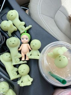 a group of toy figures sitting on top of a car dashboard