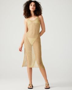 Upgrade your swim coverup game with the ANISHA dress. This metallic gold beauty features an open stitch design and sheer fabric, making it the perfect midi dress or swim coverup. Embrace the sunshine and feel glamorous in this sleeveless, shimmering piece. Open stitch metallic midi dress Can be used as a swimsuit coverup Unlined Length: 49" 76% polyester 24% metallic Hand wash cold separately, do not bleach, lay flat to dry, low iron if necessary, or dry clean Mily is 5ft 10in and is wearing a s Ceremonial Clothing, Beauty Features, Steve Madden Store, Gold Beauty, Apparel Merchandising, Swim Coverup, Americana Fashion, Dress Gold, Fabric Making