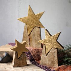 three wooden stars sitting next to each other