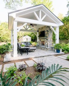 an outdoor living area with patio furniture and fireplace