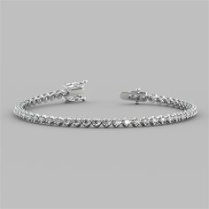 Add a touch of shimmering elegance to your look with this stunning tennis bracelet. A total of 62 dazzling Simulated Diamonds with a total weight of 2.48Ctw caress your wrist in this classic 4-prong setting with secure locking clasp. Beautifully chic, this bracelet is sure to leave you breathless. 2.48Ctw Round Cut Tennis Bracelet;  Stone Clarity: VVS-1;  Precious Metal:14K White or Yellow Gold;  Length: 7 inches;  Model: B6078A; Bracelet Stone, Diamond Tennis Bracelet, Bezel Set Diamond, Diamond Simulant, Tennis Bracelet Diamond, Precious Metal, Selling Jewelry, Tennis Bracelet, Sterling Silver Bracelets