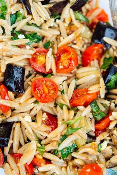 a white plate topped with pasta and vegetables