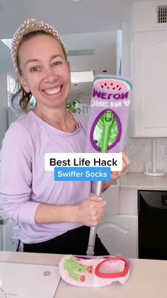 a woman is holding up a card that says best life hack swiffer socks