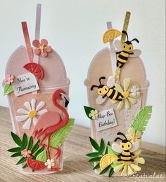 two cards made to look like vases with flowers and bees on them, one has a flamingo