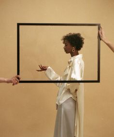 an instagram photo of two women holding up a square frame